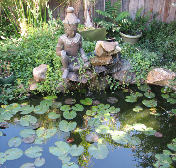 Lily pads and a buddha in a garden.  2011 Martinez Home Tour.