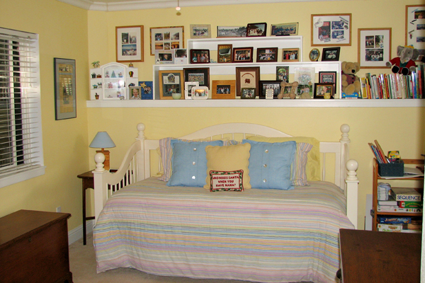 Family photographs above a daybed.  Martinez Home Tour.